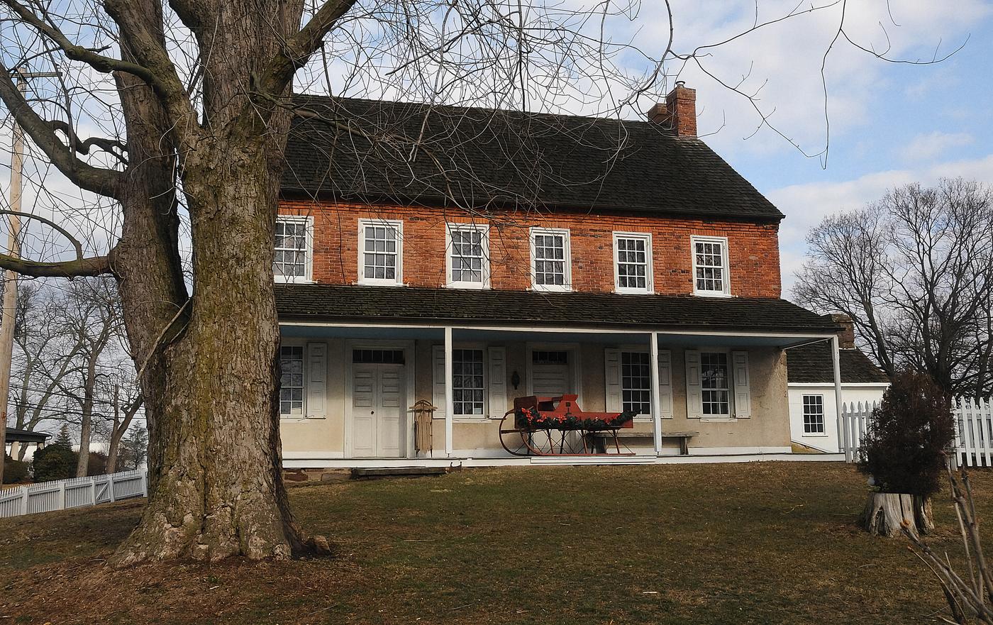 A Bucks County farmstead: stone walls, a shingle roof, and a porch that arrived a century after the house did. An appraiser reads a place like this one wall at a time.