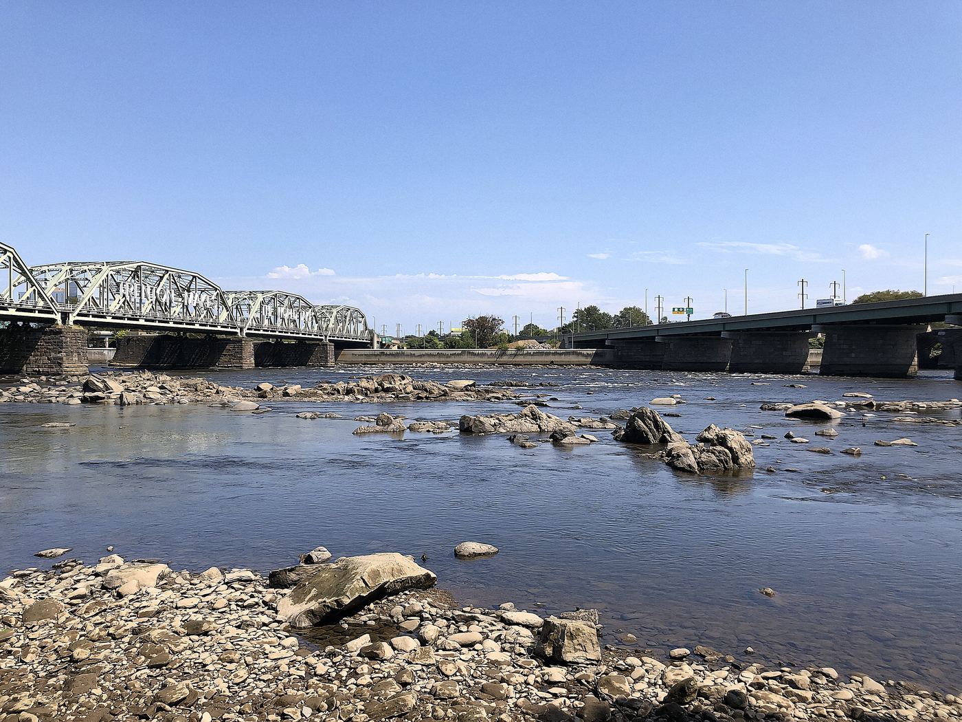 The falls of the Delaware at low tide, looking across to Trenton. This is the river that decides which Morrisville addresses need flood insurance and which do not.