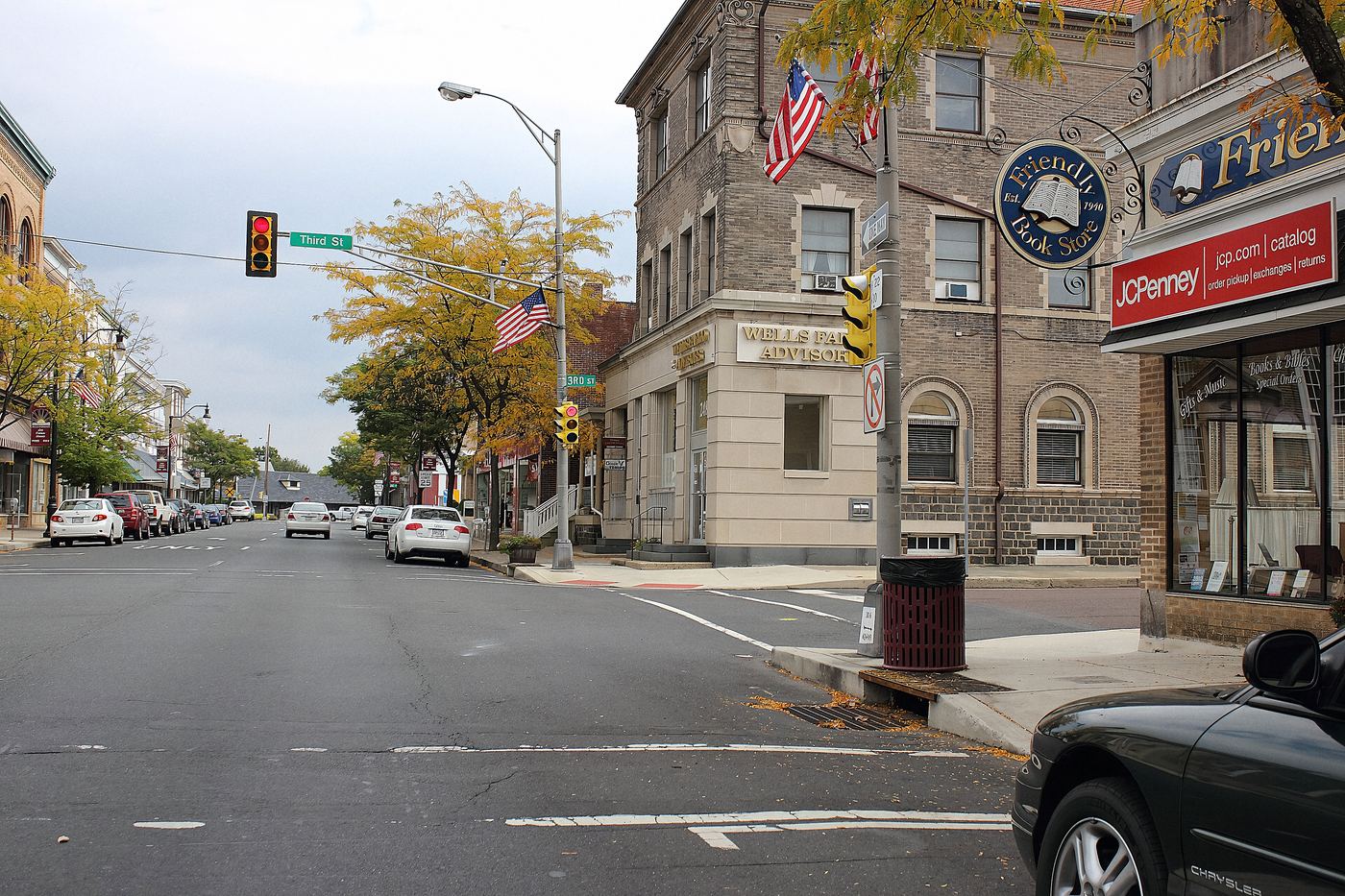 Broad Street in the Quakertown historic district. Brick corner buildings, storefronts at street level, apartments over the top of them.